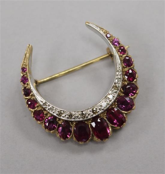 A Victorian style 9ct gold, garnet and diamond set crescent brooch, 27mm.